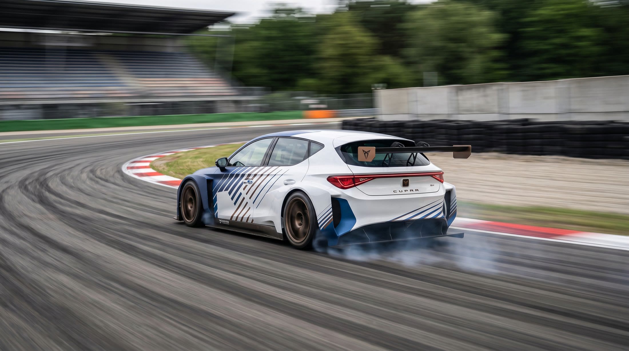 Touring car drifting through a corner on track