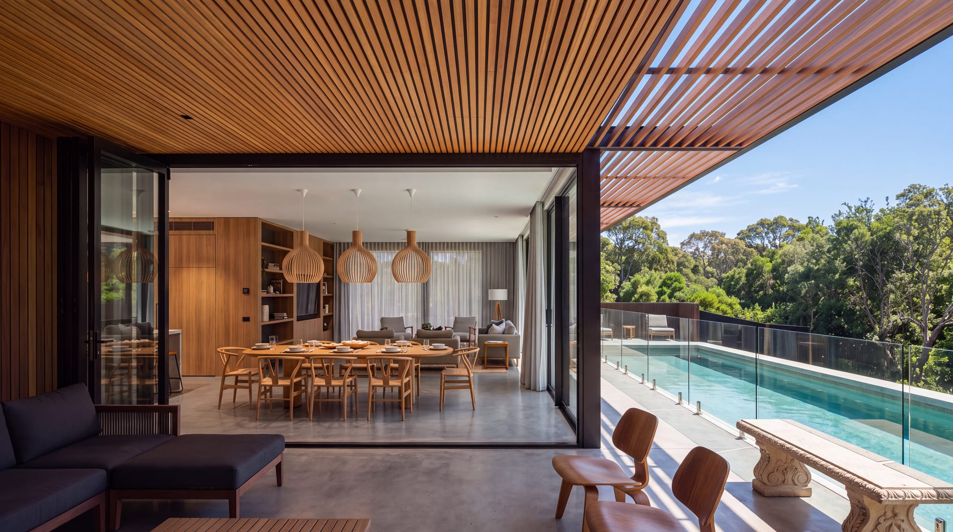 Dining room under a slatted timber ceiling in daylight
